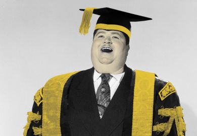 University vice-chancellor in cap and gown smiling and laughing University vice-chancellor in cap and gown smiling and laughing