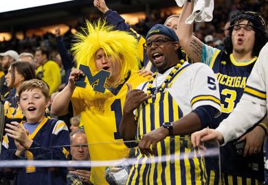 Michigan Wolverines fans celebrate in the stands during the Big 10 Championship to illustrate Change to image rights law brings a revolution in US college sports