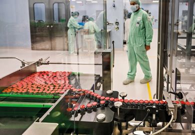 A laboratory technician supervises capped vials during filling and packaging tests of a Covid-19 vaccine candidate, 2020 A laboratory technician supervises capped vials during filling and packaging tests of a Covid-19 vaccine candidate, 2020