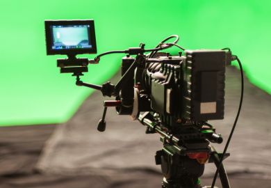 Video camera filming against green screen backdrop