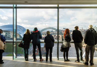 People looking out the window of the Baltic at the city view of Newcastle upon Tyne