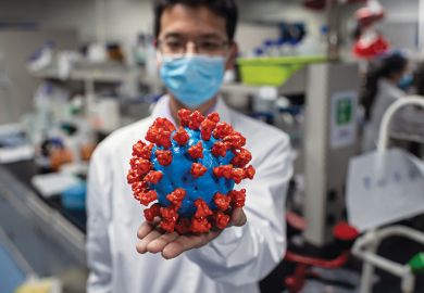 Scientist with model of coronavirus Scientist with model of coronavirus