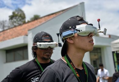 Two young men wear VR headsets