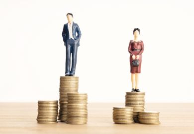 A woman stands on a lower pile of coins than a man A woman stands on a lower pile of coins than a man, symbolising the gender wage gap