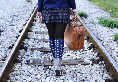 Woman walking alone on railway tracks Woman walking alone on railway tracks