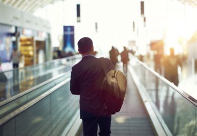 person walking on airport escalator