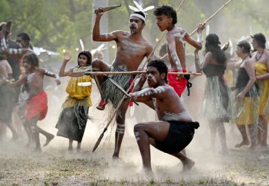 Indigenous Australians perform a cermonial war dance, illustrating culture wars