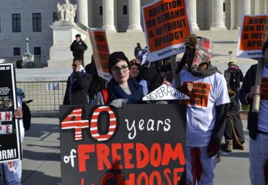 Washington D.C., USA - January 22, 2015; A Young woman holds a pro-choice sign at the U.S. Supreme Court in Washington D.C.