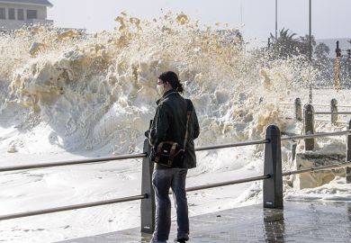 Strong winds blow large puffs of foam off the sea and into the streets of Sea Point in 2020 in Cape Town, South Africa