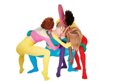 Four women with their arms artistically around each other