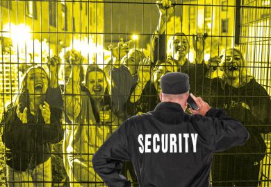 Security guard in front of fence with crowd smiling people behind Security guard in front of fence with crowd smiling people behind