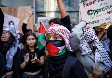 Students from Hunter College chant and hold up signs during a pro-Palestinian demonstration at the entrance of their campus to illustrate Israeli war revives academic freedom turmoil on US campuses