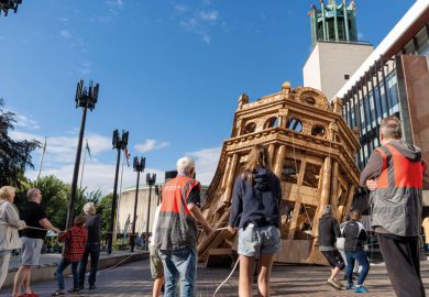 Volunteers help with the demolition of the 'Monumental Construction' - a 45ft (14 metre) cardboard building created by French visual artist Olivier Grossetete to illustrate Top UK laboratories adjust as Wellcome Trust cuts core funding