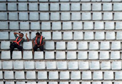 Officials sit among empty benches during the ninth match of the Asia Cup one-day cricket tournament to illustrate Indian PhD diaspora leaves universities short of recruits