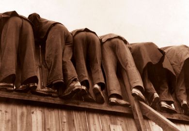 row of men bent over fence