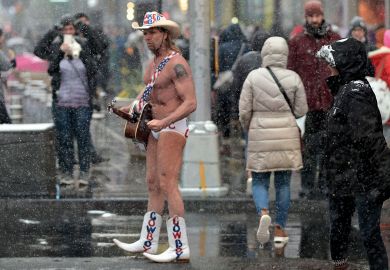 Street performer Naked Cowboy walks through the snow on Time Square to illustrate Open science funding cuts leave us ‘unprepared’ for next pandemic