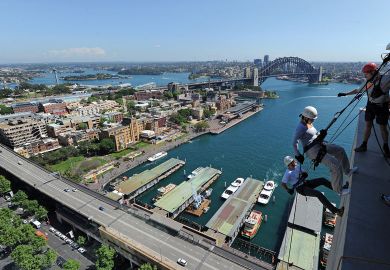 Two people abseil down the side of the Australian insurance and financial giant AMP's headquarters in Sydney to illustrate Elite university diversity drive raises Australian eyebrows