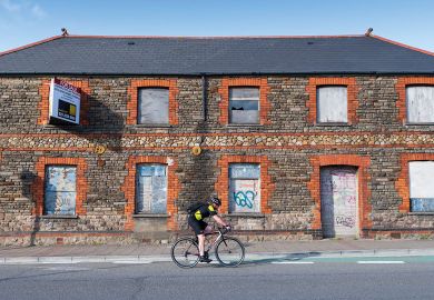 A cyclist rides past a boarded up retail unit  A cyclist rides past a boarded up retail unit to illustrate UK’s university investment zones echo US, but leave questions