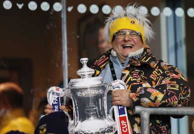 Oxford United fan with a replica Cup Trophy to illustrate Create PhD databases to flush out fraudsters, universities told