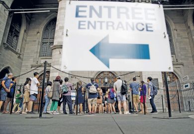Tourists wait in line outside the Notre-Dame Basilica in Montreal, Quebec, Canada to illustrate Universities blindsided as Quebec set to double non-