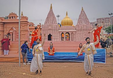 Artists perform in front of a replica of Kashi Vishwanath Dham Corridor to illustrate India’s fake universities proliferate as demand outstrips supply