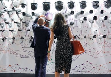 People look at surveillance cameras at the annual Huawei Connect event in Shanghai, China to illustrate Party strengthens control of Chinese university administration