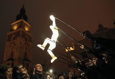 Puppet artists of the performance group Dundu move a puppet on the Main Square in Cracow, Poland Puppet artists of the performance group Dundu move a puppet on the Main Square in Cracow, Poland to illustrate Scientists fear creeping political influence over Polish academy