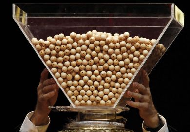 Lottery balls are dropped into a rotating drum before the start to illustrate Netherlands plots cautious return to degree admission lotteries