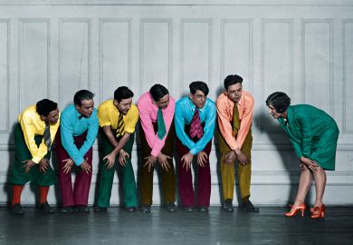 Rehearsal of a show of a group in a line holding their knees to illustrate For academia and policymakers, relationships are key to impact