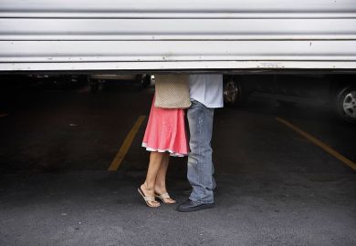 Couple behind garage shutters Couple behind garage shutters to illustrate Relationships register or full ban is ‘catch-22’ for universities