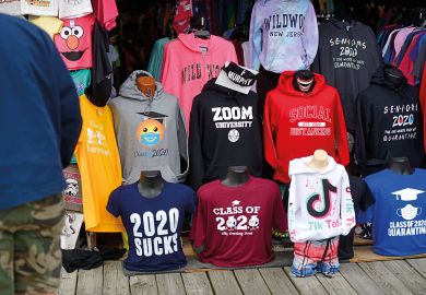 Tourists shop for boardwalk t-shirts including "ZOOM UNIVERSITY," "SOCIAL DISTANCING," and "2020 SUCKS"  Tourists shop for boardwalk t-shirts including "ZOOM UNIVERSITY," "SOCIAL DISTANCING," and "2020 SUCKS" to illustrate Leading US universities settle Covid online teaching lawsuits