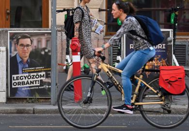 A cyclist drives past a campaign poster of the Budapest Mayor and candidate for prime minister Gergely Karacsony  'Parbeszed Magyarorszagert' (Dialogue for Hungary) reading 'I will defeat (Hungarian Prime Minister) to illustrate Hungarian election brings 