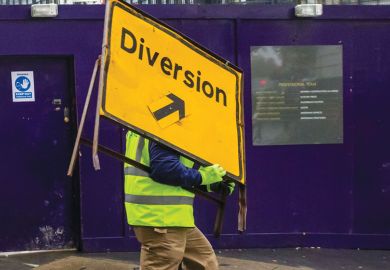 Workman moves a road diversion sign Fee freeze ‘risks exacerbating’  shift away from UK undergraduates