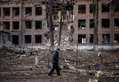 A man walks in front of a destroyed building after a Russian missile attack in the town of  Vasylkiv, near Kyiv, to illustrate Russia faces ‘devastating’ research isolation