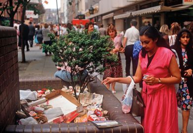 A lady drops a piece of litter on a growing pile of rubbish to illustrate ‘Treasury win’ throws HE funding worries on next government’s pile