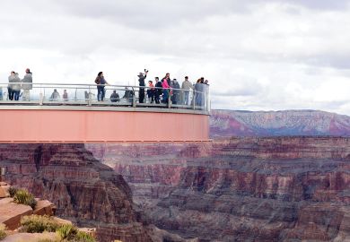 People standing on the The Skywalk on cantilever bridge in Arizona near the Colorado River