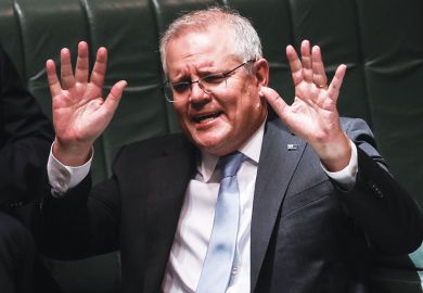 Australian Prime Minister Scott Morrison with both hands up to illustrate Australia parliament rejection.