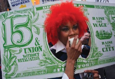 Person with red wig dressed as a fake banknote Person with red wig dressed as a fake banknote as a metaphor for US colleges face tougher scrutiny on graduate employment