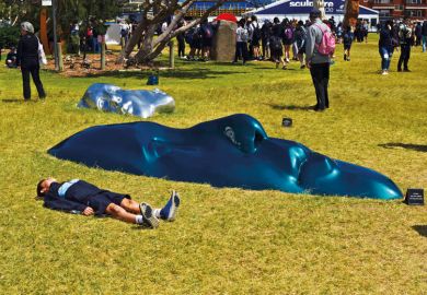 Sculpture exhibition of faces flat on the ground in Sydney, NSW, Australia to illustrate ‘Inflection point’ for disabilities in higher education