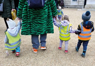 Young children in hi-vis jackets taken for a walk in London, England to illustrate Nursery time is over for UK campuses