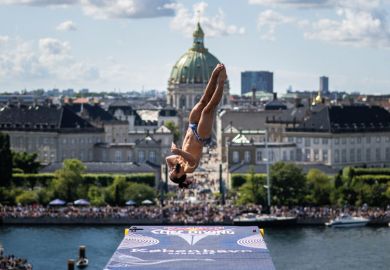  Person dives from the 28 metre platform at the Copenhagen Opera House. to illustrate regions hit hardest as Danish applications drop 11 per cent