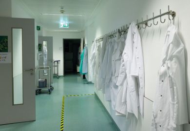 Lab coats hang in a corridor to illustrate Italian postdoctoral reforms ‘could lead to elimination of 5,000 jobs