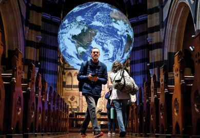 People look at a giant globe of the world measuring seven metres in diameter at St Paul's Cathedral in Melbourne  People look at a giant globe of the world measuring seven metres in diameter at St Paul's Cathedral in Melbourne