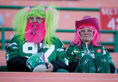 Two costumed Saskatchewan Roughrider fans  Two costumed Saskatchewan Roughrider fans to illustrate Canada’s universities tackle false claims of Indigenous identity