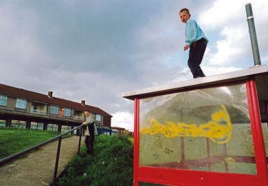 Boys playing on bus shelter on run down council estate; Bradford UK Boys playing on bus shelter on run down council estate; Bradford UK to illustrate social mobility