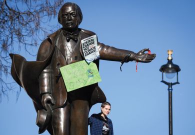  A student stands on the plinth of a statue of former Prime Minister David Lloyd George with climate change posters on the statue as a metaphor for picking fights with students ‘deflection strategy’ for ministers