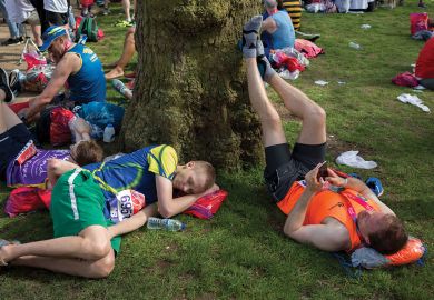 Tired long-distance runners rest after finishing the London Marathon Tired long-distance runners rest after finishing the London Marathon to illustrate people are deep tired