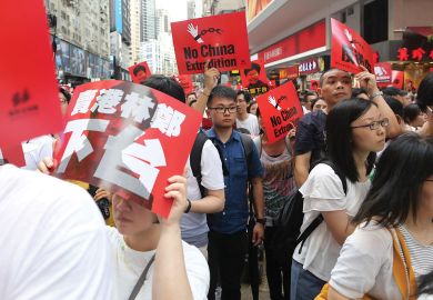 Demonstrators hold placards during the anti extradition march to illustrate Concerns Hong Kong students’ union faces on campus