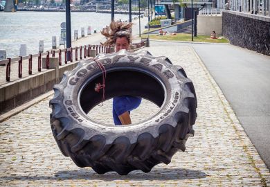 woman working out with a tractor tire in Rotterdam, The Netherlands woman working out with a tractor tire in Rotterdam, The Netherlands to illustrate Recast Rutte coalition promises  to invest in tackling HE workloads