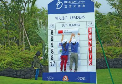 Scorers make a change on a scoreboard in Hainan Island, China to illustrate ‘Up-or-out’ systems heap pressure on junior academics in China